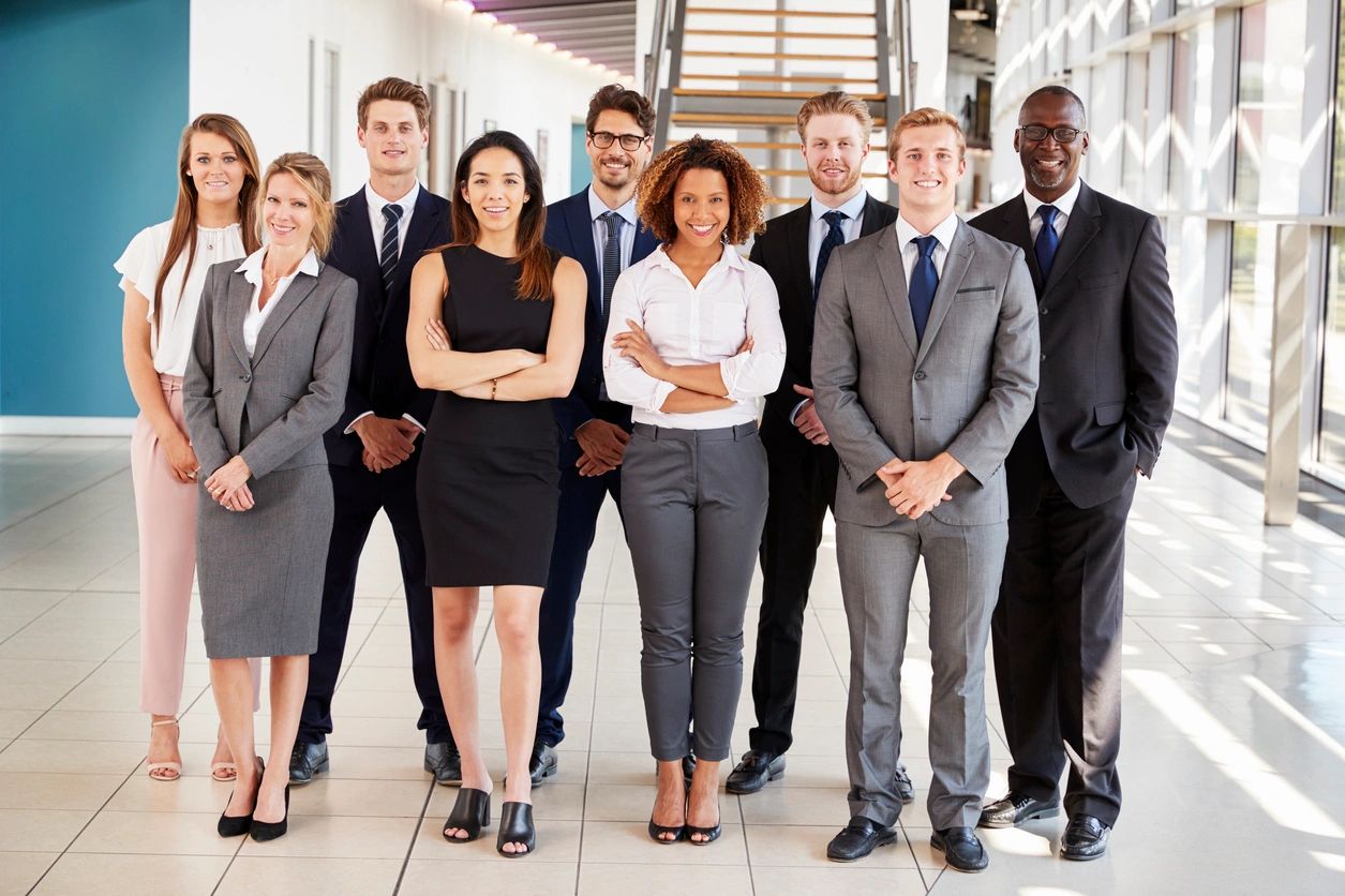 A group of people in business attire standing together.